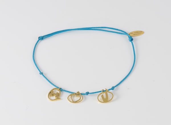 Pulsera La Mome Bijou hilo azul y letras colgantes de oro amarillo 18k