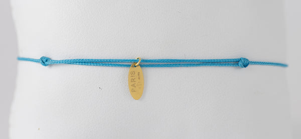 Pulsera La Mome Bijou hilo azul y letras colgantes de oro amarillo 18k